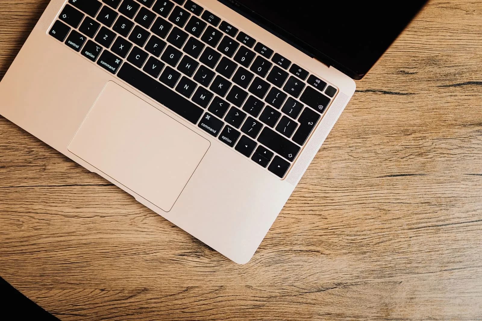 A laptop on a wooden table